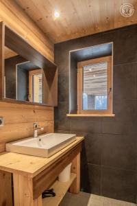 a bathroom with a sink and a mirror at Chalet Alpin Luxe, Jacuzzi, Vue in Champagny-en-Vanoise