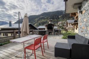 a patio with a table and chairs and a fireplace at Chalet Alpin Luxe, Jacuzzi, Vue in Champagny-en-Vanoise
