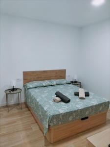 a bedroom with a bed with two towels on it at Apartamento D&L in Costa Del Silencio