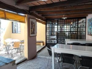 a dining room with a table and chairs and a book shelf at Estancia el Cimarrón in La Granja