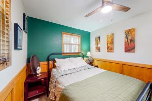 a bedroom with a bed and a green wall at The Cove - Main House in Golden