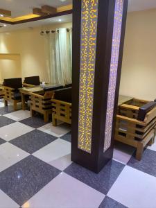 a room with tables and chairs and a pillar at Rameshworam Hotel in Kathmandu