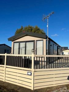 a house behind a wooden fence with a gate at Coastguard 45 in Whitstable