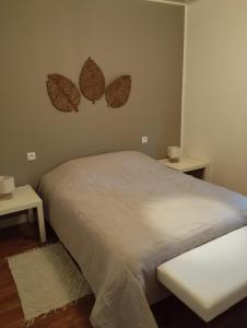 a bedroom with a bed with two hearts on the wall at Les petits cailloux in Saint-Médard-de-Mussidan