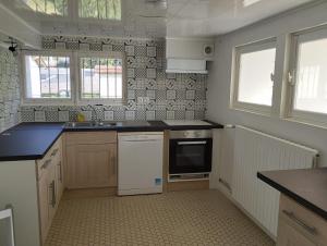 a kitchen with a sink and a dishwasher at Les petits cailloux in Saint-Médard-de-Mussidan