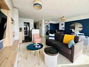 a living room with a couch and a table at Appartement rénové à neuf avec vue imprenable sur la baie des Sables d Olonne 6 pers in Les Sables-dʼOlonne