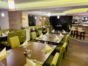 a restaurant with tables and chairs and a christmas tree at Hotel Pruggererhof in Pruggern