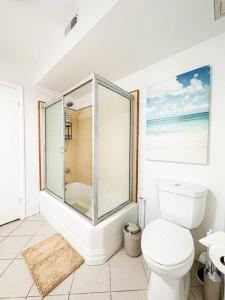 a white bathroom with a toilet and a shower at Relaxing 6 BR Oasis with Pool - Lou1 in Los Angeles