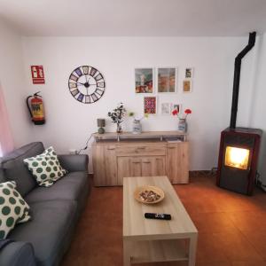 a living room with a couch and a table at CASITAS PINILLA DEL VALLE in Pinilla del Valle