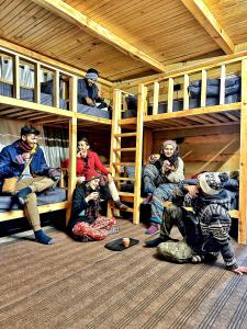 a group of people sitting in a bunk bed at RAFA Shangarh in Sainj