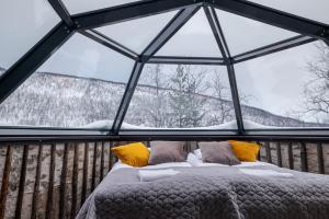 a bedroom with a bed in a glass igloo at Holiday Village Valle in Utsjoki