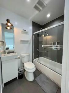 a bathroom with a toilet and a tub and a sink at Ideal Townhouse in Mid City - CR1-CUL in Los Angeles