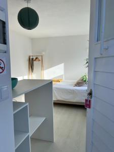 a room with a bed and a desk and a door at Maria Studio in Cascais +4 photos
