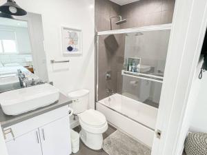 a bathroom with a toilet and a sink and a shower at Stylish Townhouse in Mid City - CR2-CUL in Los Angeles