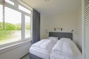 Ένα ή περισσότερα κρεβάτια σε δωμάτιο στο Vakantiehuis Solea - Julianadorp aan Zee