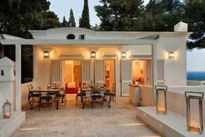 un patio al aire libre con mesas, sillas y luces en Villa Bouganvillea Superb Capri Villa with Views en Capri