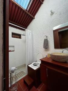 a bathroom with a toilet and a sink and a mirror at Casa Del Viento, Alojamiento in Villanueva