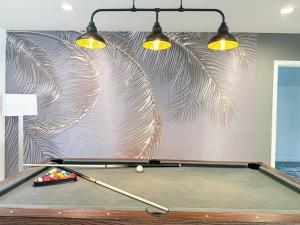 a pool table with two lights on a wall at Cozy 3BR Oasis for Your Next Adventure in LA - WO in Los Angeles