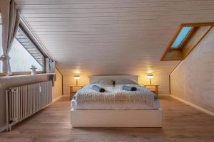 a bedroom with a white bed in a attic at Köhlerstube Todtmoos in Todtmoos