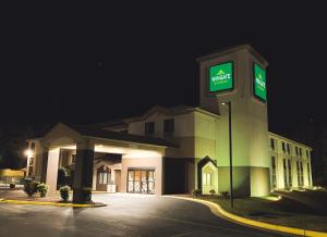 a large building with a sign on it at night at Wingate by Wyndham Salisbury in Salisbury