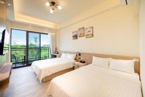 Vuode tai vuoteita majoituspaikassa 小琉球遇見海旅宿