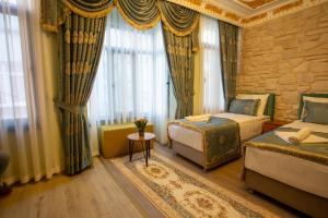 a hotel room with two beds and a window at Sayina Hotel in Istanbul