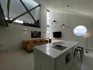 a kitchen and living room with a couch and a table at Departamento duplex diseño exclusivo in Huancayo