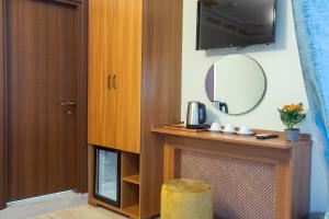 a room with a vanity with a mirror and a tv at Sayina Hotel in Istanbul