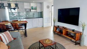 a living room with a large flat screen tv at Luxury Apartment in Casilla de Costa - Casa MEVA in Lajares