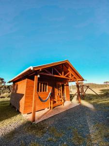 a small wooden cabin with a roof at Casa de Campo Santa Paulina in Urupema