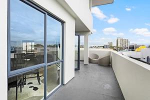 an apartment balcony with a view of a city at Freeman Escape with garage parking in Auckland
