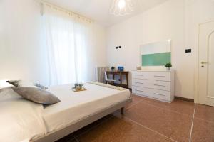 a bedroom with a bed with a dresser and a mirror at Realkasa Kharkov Apartment in Bologna
