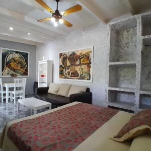 a bedroom with a bed and a living room with a couch at El Cimarron Casa de Campo in La Granja