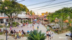 a group of people walking down a street at Topázio Pousada in Morro de São Paulo