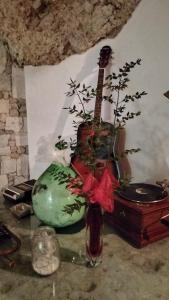 a vase with a guitar sitting on a table at AL CANTINONE in Toffia