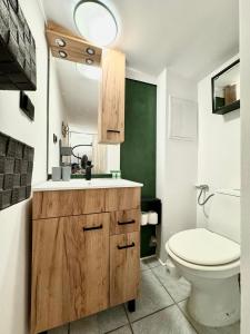 a bathroom with a sink and a toilet in it at Apartament Dotyk - Monte Cassino- Kameralne Poddasze in Sopot
