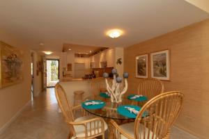 a dining room and kitchen with a table and chairs at Palms 407 in Islamorada