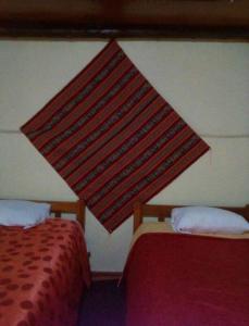 una cortina colgando sobre dos camas en una habitación en Siwar qoyllur 