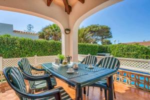 a blue table and chairs on a patio at Aure Villa con piscina y aire acondicionado! in Cala'n Bosch