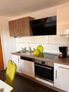 a kitchen with a sink and a stove top oven at Schönes Zimmer im Zentrum - 2 in Paderborn +2 photos