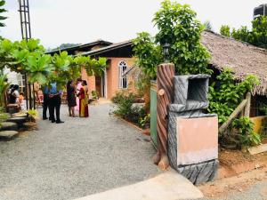 a group of people standing outside of a building at Samara Nature Paradise in Kalutara