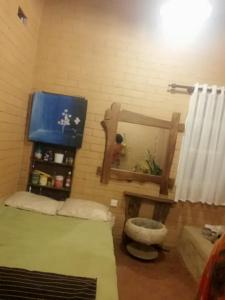 a living room with a bed and a mirror at Samara Nature Paradise in Kalutara