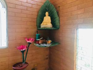 a wall with a statue of a buddha in a room at Samara Nature Paradise in Kalutara