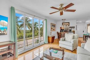 a living room with a couch and a ceiling fan at Palms 417 in Islamorada