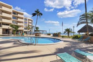 a swimming pool with chairs and a resort at Palms 417 in Islamorada