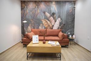 a couch in a room with a wall with a mural at Caravin Wanderhome in Athens