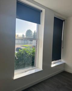 an empty room with a window with a view at ASM London Road Studio Apartments in Leicester