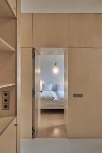 a bedroom with a bed with white pillows at LE GARAGE Downtown serviced apartment in The Hague