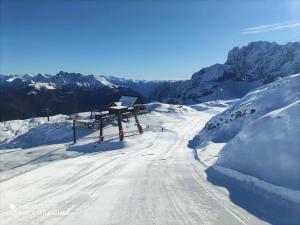 a snow covered ski slope with a ski lift at Casa Cardillo in Colere