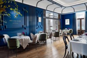 a dining room with tables and chairs and blue walls at Palacio Arriluce Hotel in Getxo